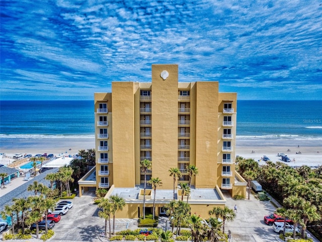 view of property featuring a water view and a view of the beach