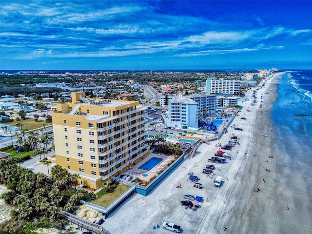 bird's eye view featuring a water view, a view of city, and a view of the beach