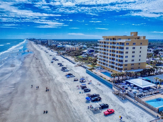 drone / aerial view featuring a view of the beach and a water view