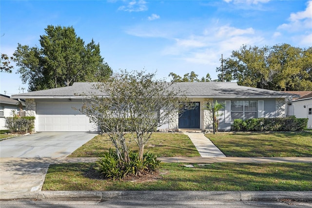 view of front of house featuring an attached garage, concrete driveway, and a front yard