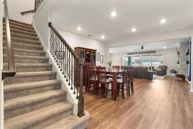 dining area featuring stairs, recessed lighting, visible vents, and wood finished floors