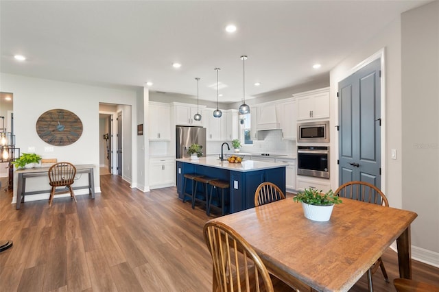 dining room with recessed lighting, dark wood-style flooring, and baseboards