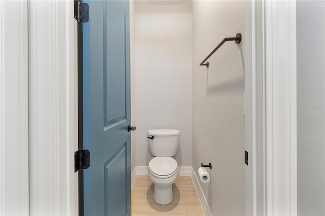 bathroom featuring wood finished floors, toilet, and baseboards