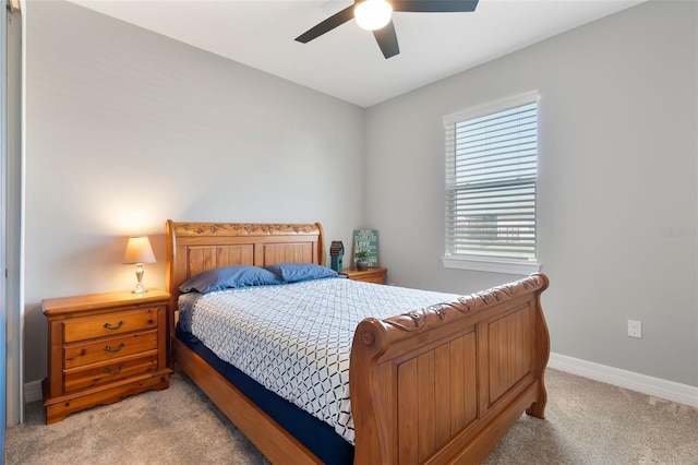 bedroom featuring light carpet, ceiling fan, and baseboards