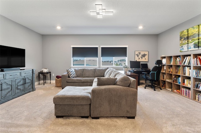 carpeted living area with baseboards and recessed lighting