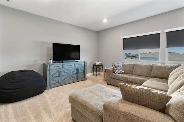 living room with light carpet and baseboards