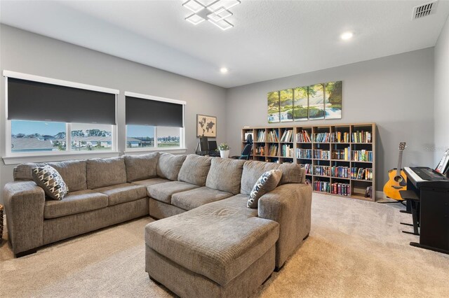 carpeted living room featuring visible vents and recessed lighting