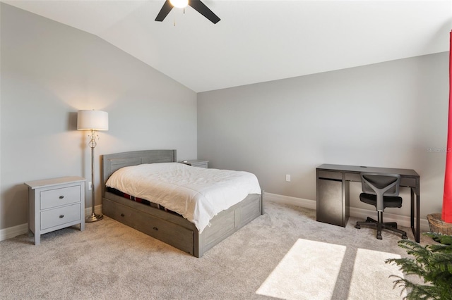 bedroom with lofted ceiling, baseboards, a ceiling fan, and light colored carpet