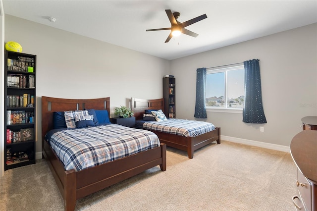 bedroom with carpet, baseboards, and a ceiling fan