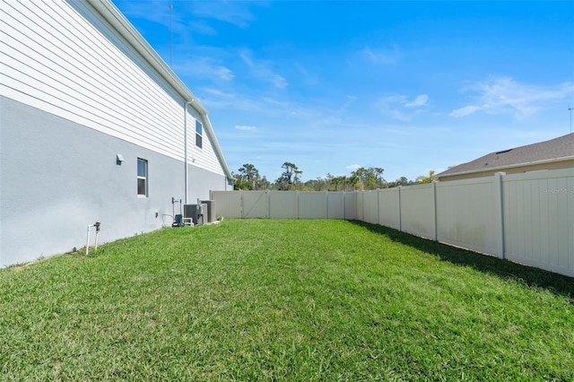 view of yard with a fenced backyard and cooling unit