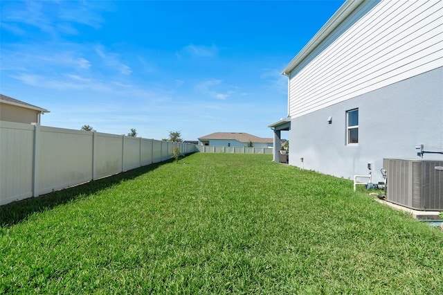 view of yard featuring a fenced backyard and central AC unit