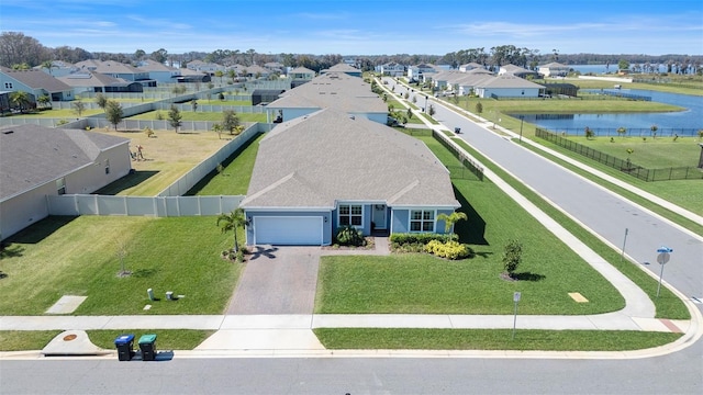 bird's eye view featuring a water view and a residential view