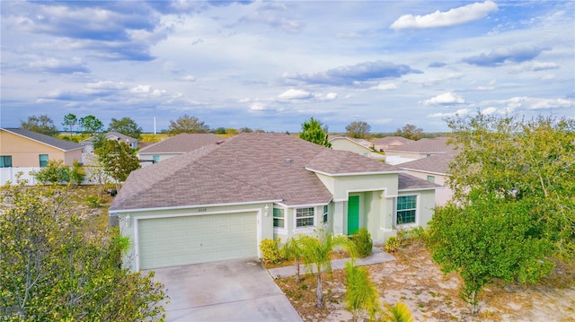 ranch-style house with concrete driveway, an attached garage, and stucco siding