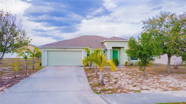 view of front of property featuring a garage, driveway, and stucco siding