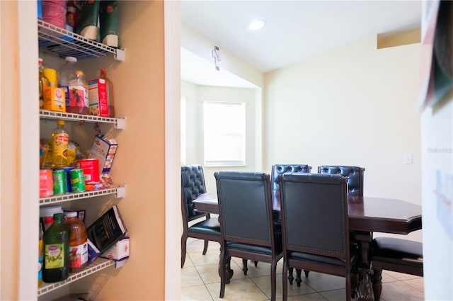 tiled dining space featuring recessed lighting