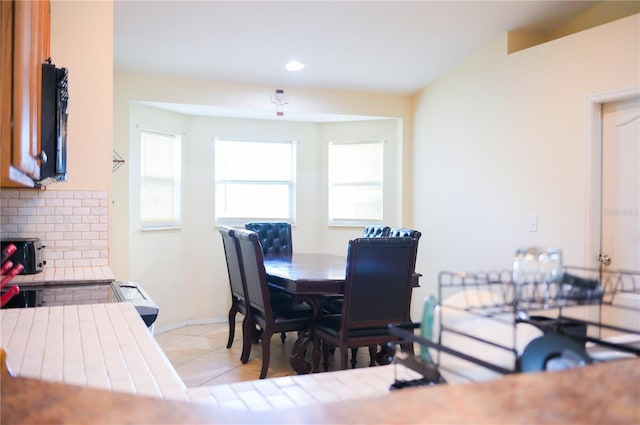 dining area with light tile patterned floors, baseboards, and recessed lighting