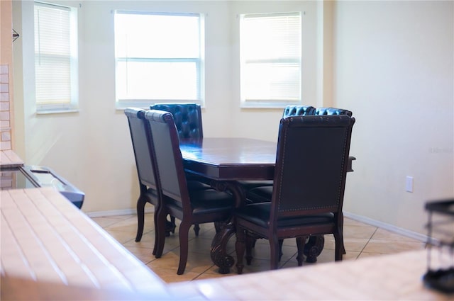 dining space with light tile patterned floors and baseboards