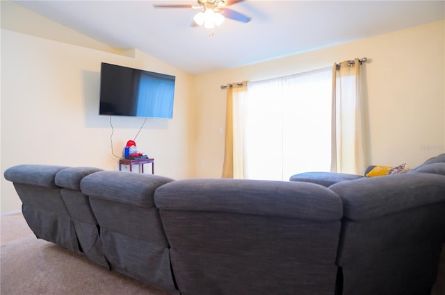 living room featuring vaulted ceiling, carpet flooring, and a ceiling fan