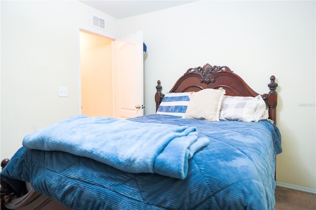 carpeted bedroom featuring visible vents and baseboards