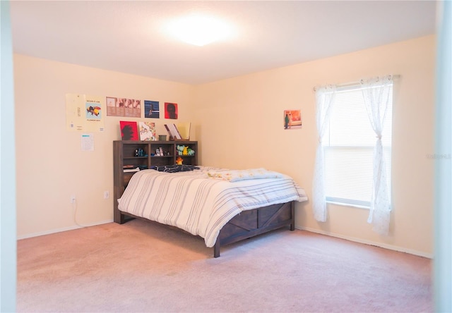 bedroom featuring carpet and baseboards