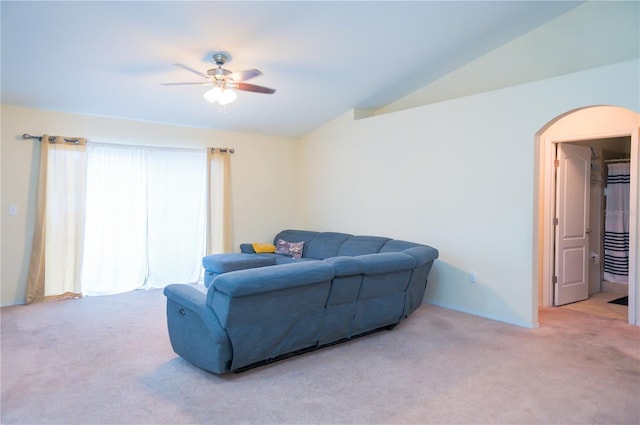 carpeted living area with lofted ceiling and ceiling fan