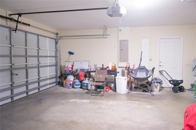 garage featuring electric panel and a garage door opener