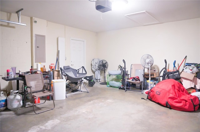 garage with electric panel and a garage door opener