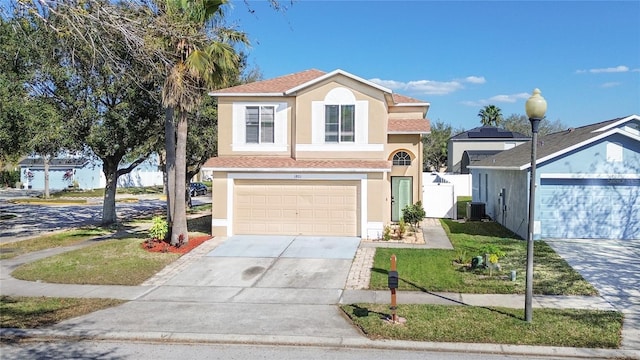 view of front of house with driveway, an attached garage, central AC, and stucco siding