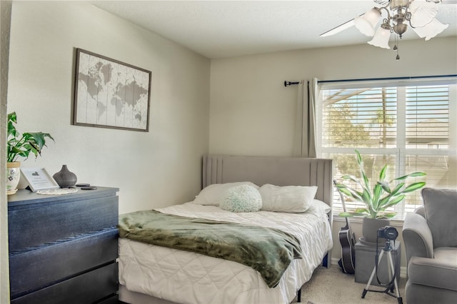 bedroom with multiple windows, a ceiling fan, and light colored carpet