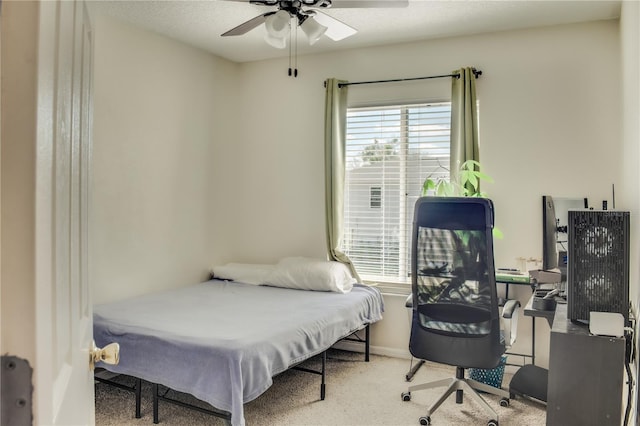 carpeted bedroom featuring a ceiling fan and baseboards