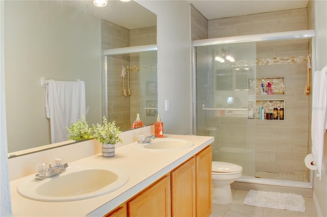 full bathroom with a stall shower, a sink, and tile patterned floors