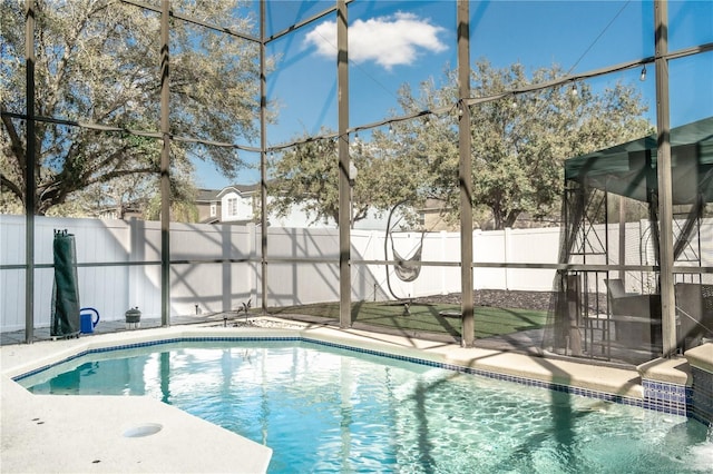 view of swimming pool featuring a fenced backyard, a fenced in pool, and a lanai