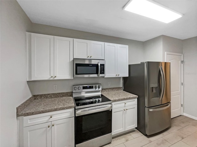 kitchen with appliances with stainless steel finishes and white cabinets