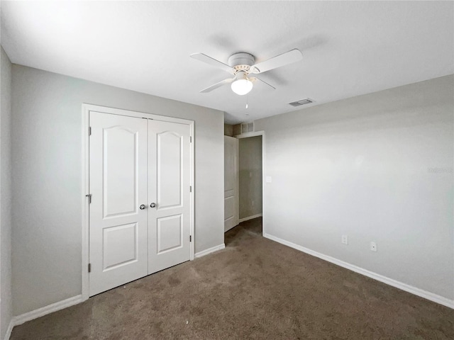 unfurnished bedroom featuring carpet floors, a closet, visible vents, and baseboards