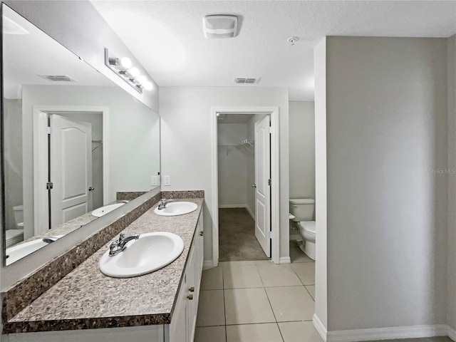 bathroom featuring visible vents, a sink, and toilet