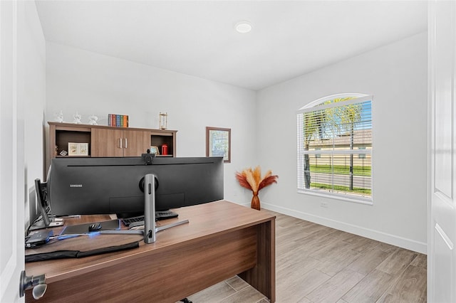 office space with light wood finished floors and baseboards