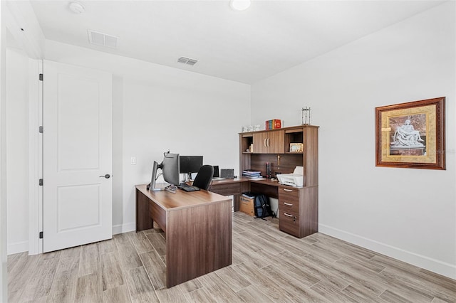 office space featuring baseboards, visible vents, and light wood-style floors