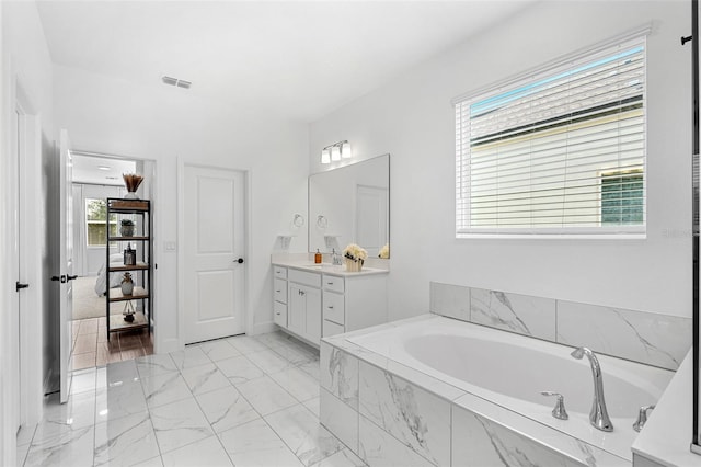 full bath with a bath, visible vents, marble finish floor, and vanity