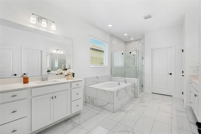 bathroom with a bath, marble finish floor, vanity, and a marble finish shower