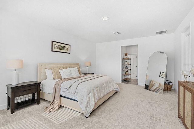 carpeted bedroom featuring visible vents and baseboards