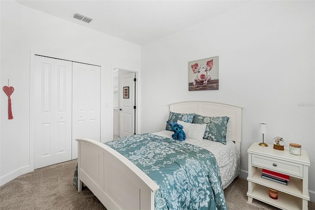 carpeted bedroom featuring a closet, visible vents, and baseboards