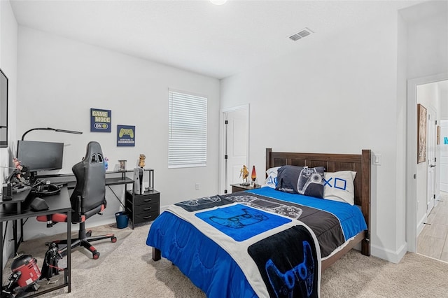 bedroom with baseboards, carpet flooring, and visible vents