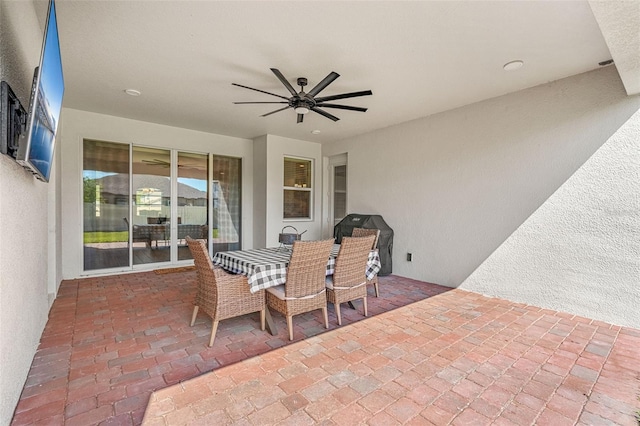 view of patio featuring outdoor dining space and ceiling fan