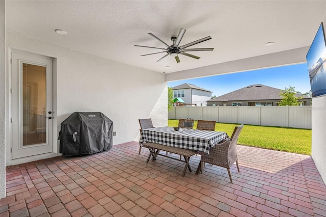view of patio with grilling area, a ceiling fan, a fenced backyard, and outdoor dining area