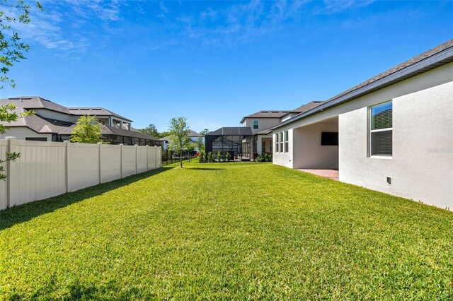 view of yard featuring fence and a residential view