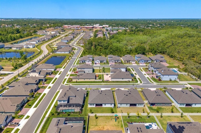 bird's eye view with a residential view and a water view