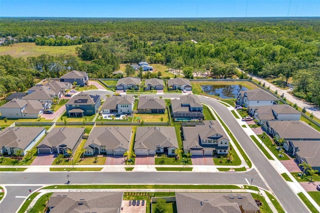 bird's eye view featuring a forest view and a residential view