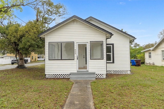 bungalow featuring entry steps, a front lawn, and crawl space