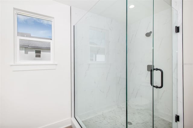 bathroom featuring a marble finish shower and recessed lighting