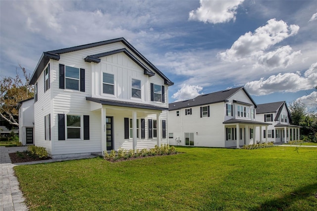 view of front of house featuring board and batten siding and a front yard